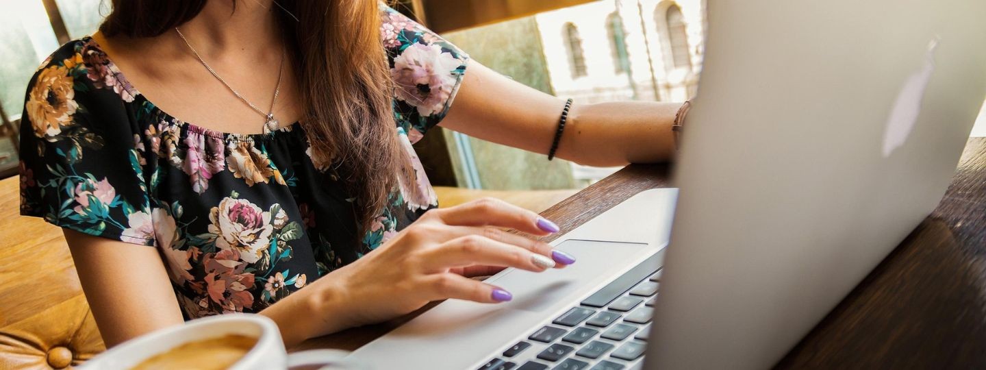 Frau arbeitet am Laptop – Betriebshaftpflichtversicherung für Unternehmen und Selbstständige