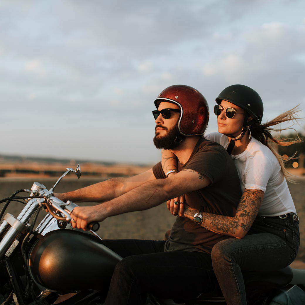Ein Motorrad mit einem Mann und einer Frau auf einer Straße
